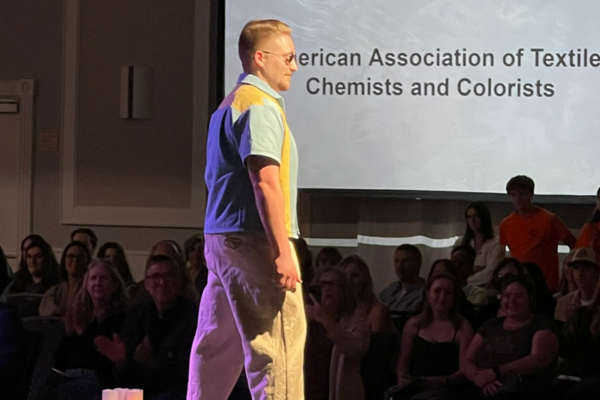 Student walks the AATCC club fashion show in a hemp outfit.