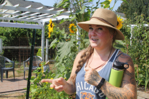 Marianne Williamson standing in her garden